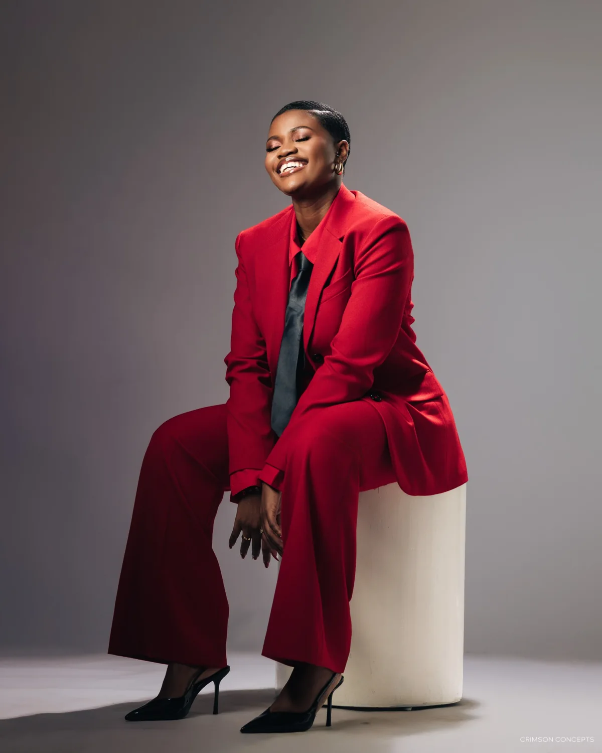 Kweyakie in a red suit